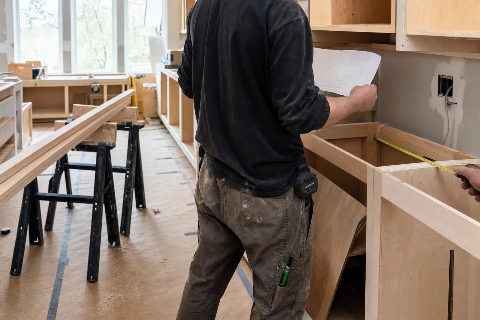 Representative image of a general contractor reviewing plans during a kitchen renovation